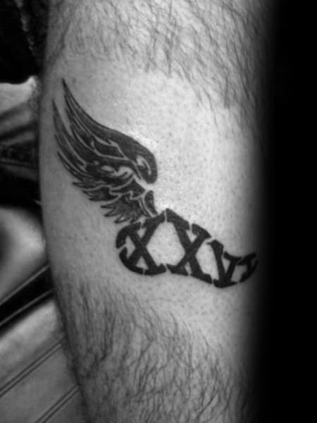 Winged Roman numerals tattoo featuring “XXVI” to symbolize 26.2 miles, representing strength and the spirit of a marathon runner.