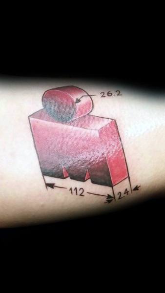 Geometric Ironman logo tattoo in 3D style with labeled race distances: 2.4 swim, 112 bike, and 26.2 run, representing full Ironman.