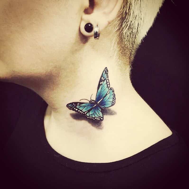 Woman's neck with a delicate blue butterfly tattoo near the left ear
