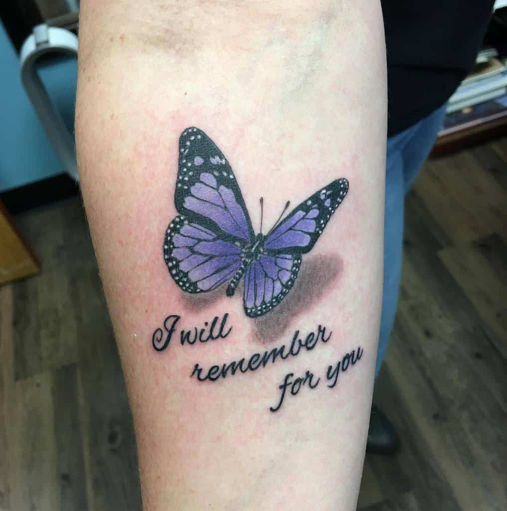 Tattoo of a purple butterfly with the text "I will remember for you" on forearm