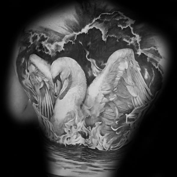 Swan tattoo design with wings spread wide, surrounded by stormy clouds and flames, reflecting power and grace on the water.