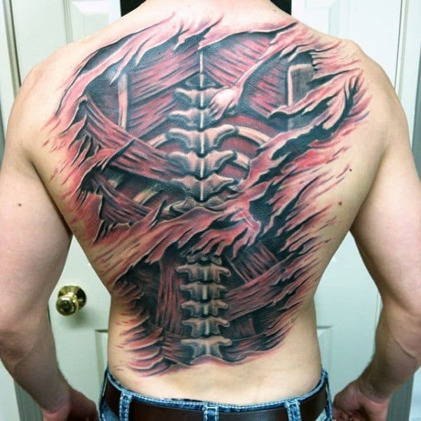 Full back tattoo showing a ripped skin effect revealing the spine and muscles beneath, with dramatic red and black shading.