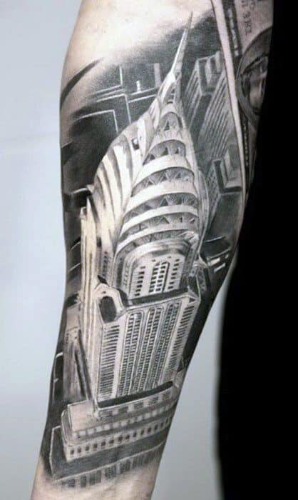 Realistic black and gray forearm tattoo of the Chrysler Building viewed from above, showcasing intricate architectural details.