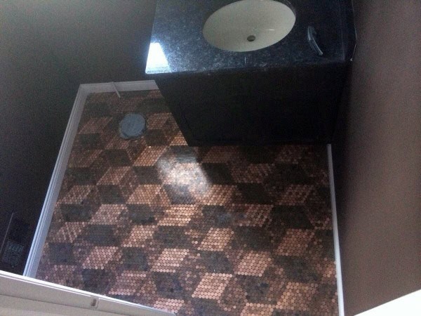 Bathroom with penny tile floor in a 3D cube pattern and dark vanity with granite countertop.
