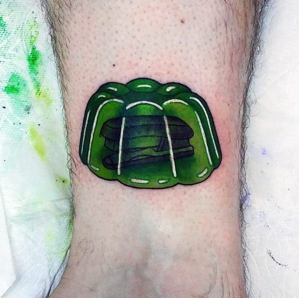 Green Jell-O tattoo with a stapler inside, inspired by The Office prank where Jim encases Dwight's stapler in gelatin.