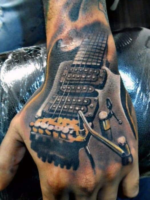 Tattoo of an electric guitar on the back of a person's hand