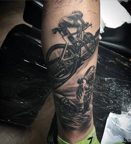 Detailed black and grey tattoo of a cyclist in motion, capturing the intensity of an Ironman race.