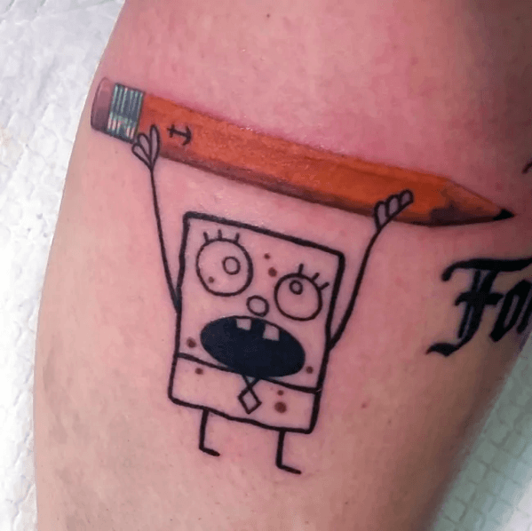 Tattoo of DoodleBob holding a realistic colored pencil above his head with a shocked expression, blending cartoon and realism.