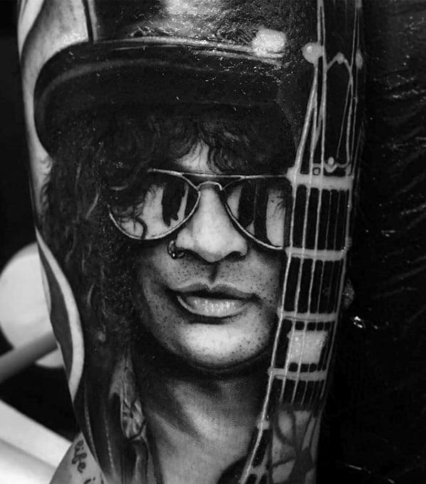 Hyper-realistic black and grey tattoo of Slash with sunglasses, a top hat, and guitar neck, capturing the iconic Guns N' Roses guitarist.