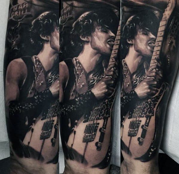 Detailed tattoo of Prince passionately playing an electric guitar on someone's arm