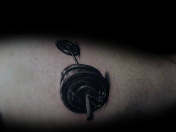 Realistic black and gray barbell tattoo with detailed shading, symbolizing strength, discipline, and dedication to weightlifting and fitness.