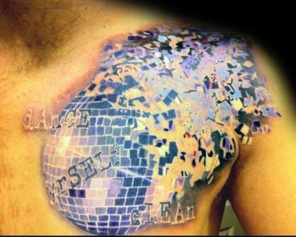 Creative disco ball tattoo on a man's chest with a shattered mirror effect, blending pixelated tiles into the skin for a unique design.