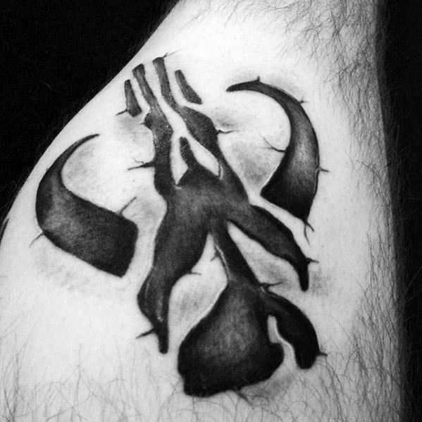 Mandalorian Mythosaur skull tattoo with bold black shading and rugged, tribal-style edges on upper arm.