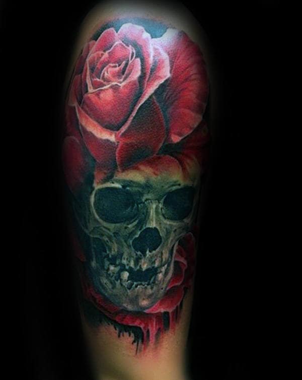 Tattoo of a red rose over a skull