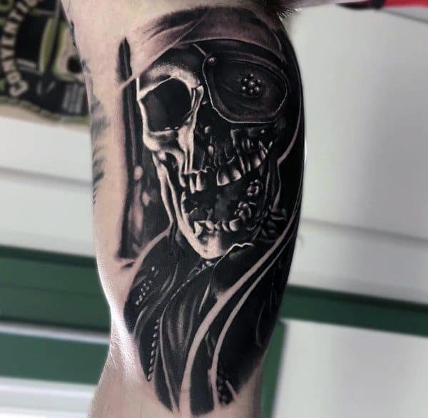 Realistic black and gray tattoo of One-Eyed Willy from The Goonies featuring a detailed skull with a pirate bandana and eye patch.