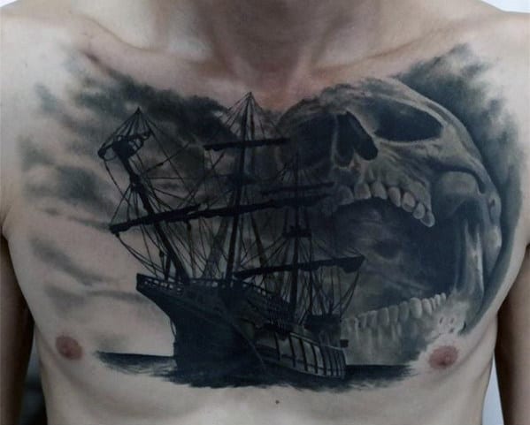 Chest tattoo of a sailing ship in stormy seas with a giant skull looming behind it, creating a dramatic, dark scene