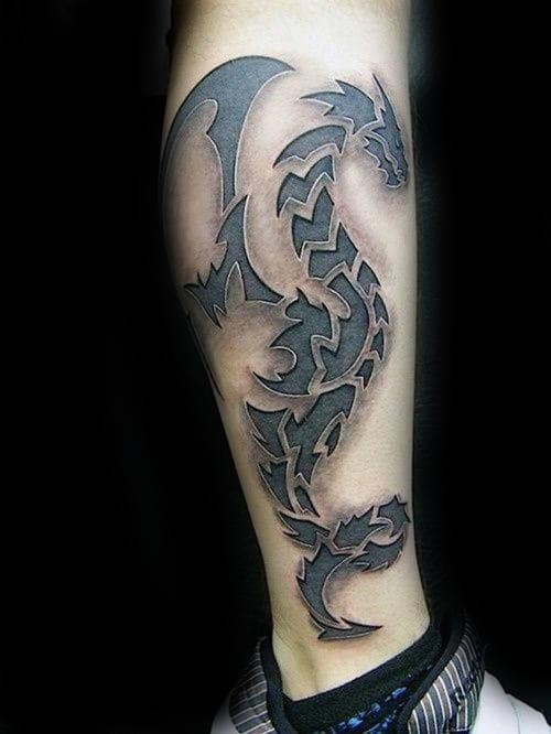 Tattoo of a tribal-style dragon design on a calf
