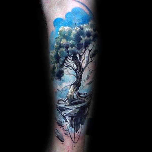 Fantasy-inspired tattoo of a lush tree growing on a floating island with rocky roots, surrounded by swirling blue clouds, symbolizing freedom and imagination.