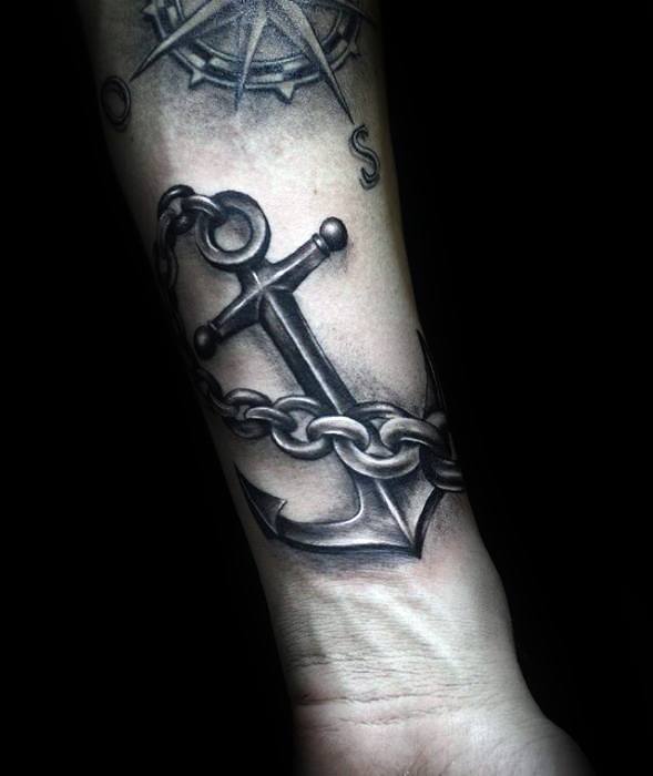 Forearm tattoo of an anchor with a chain, shaded in black and gray ink