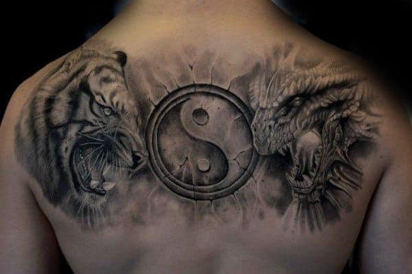 Back tattoo featuring a roaring tiger, a dragon, and a yin-yang symbol in the center