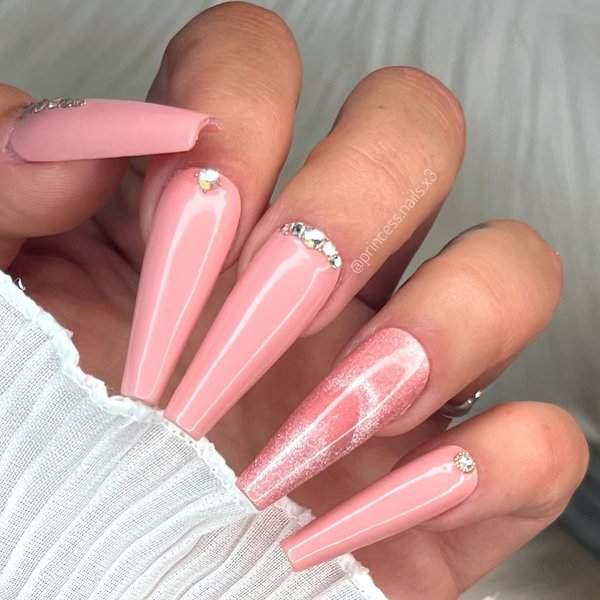 Long pink nails with rhinestone accents