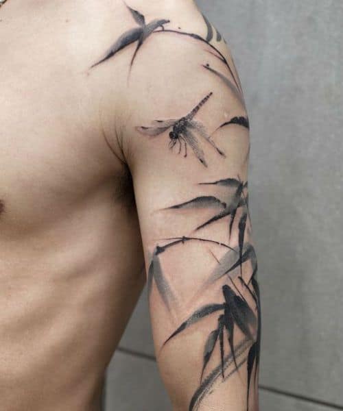 Elegant black and grey dragonfly and bamboo tattoo sleeve, featuring soft brushstroke shading for an artistic, nature-inspired design.