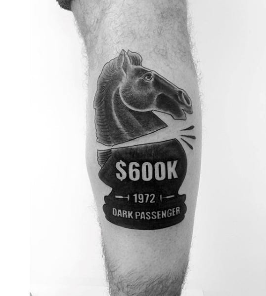 Tattoo of a horse with "$600K 1972 Dark Passenger" text on a leg