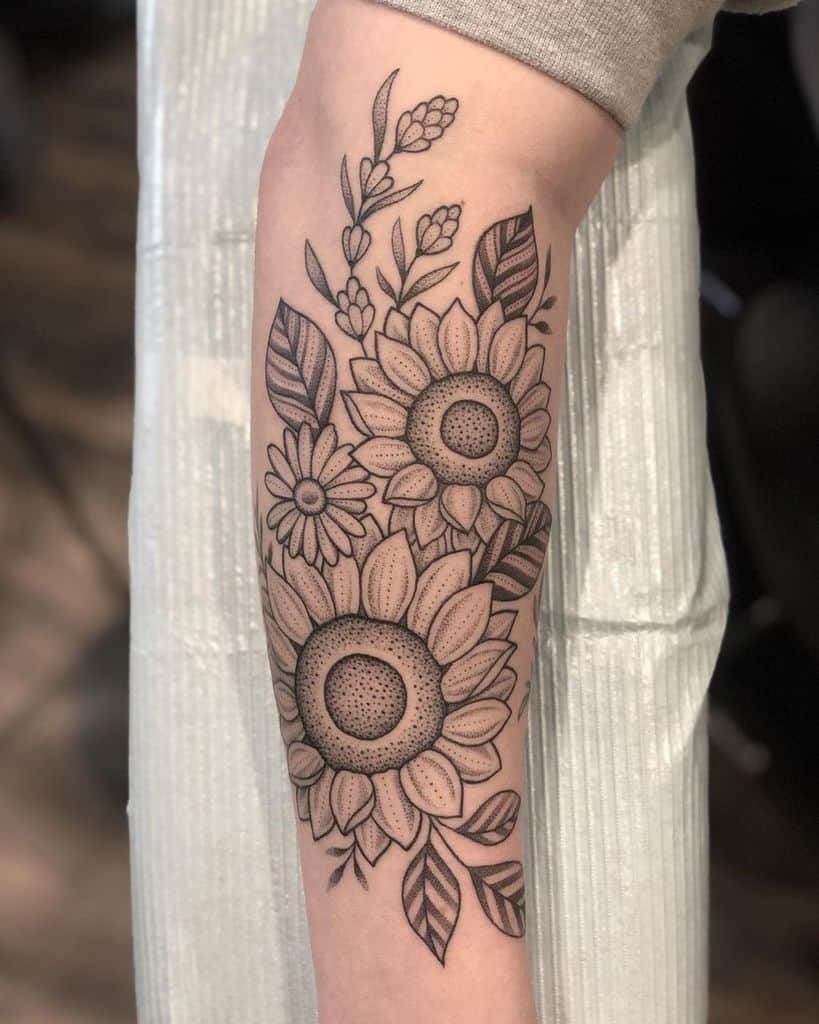 Intricate black and grey sunflower tattoo on forearm with fine line details, dot shading, and floral elements for a delicate look.
