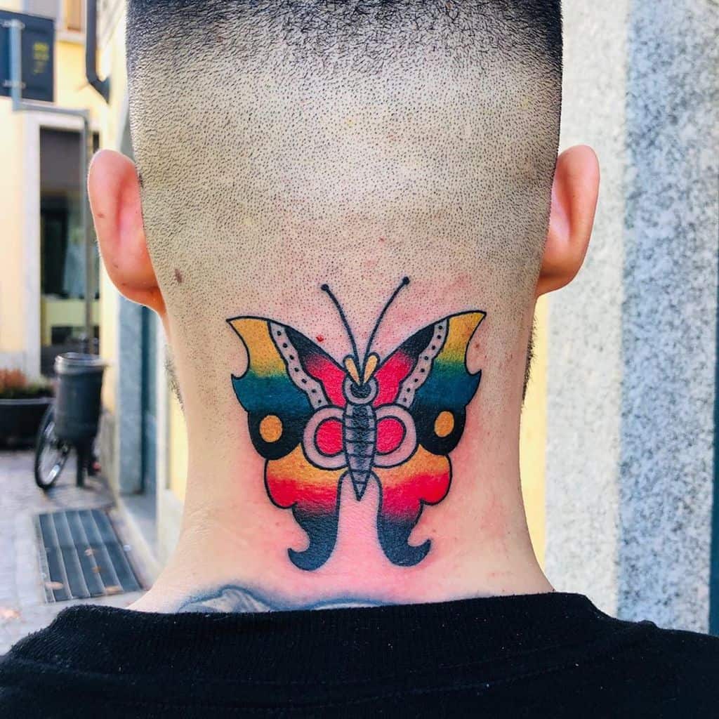 Bold and colorful butterfly tattoo on the back of the neck, featuring vibrant red, yellow, and blue hues with a traditional design style.