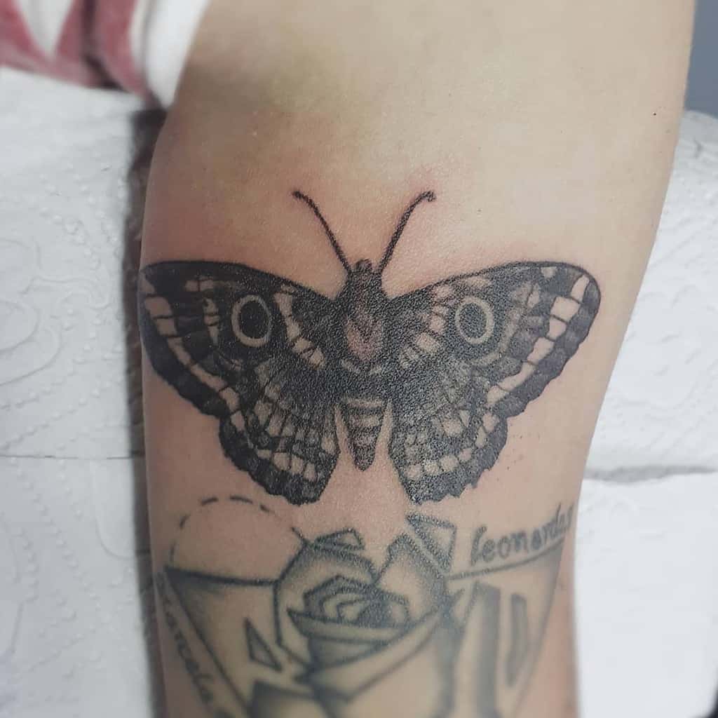 Intricate black and grey moth tattoo with fine details and shading, creating a bold and mystical design on the skin.