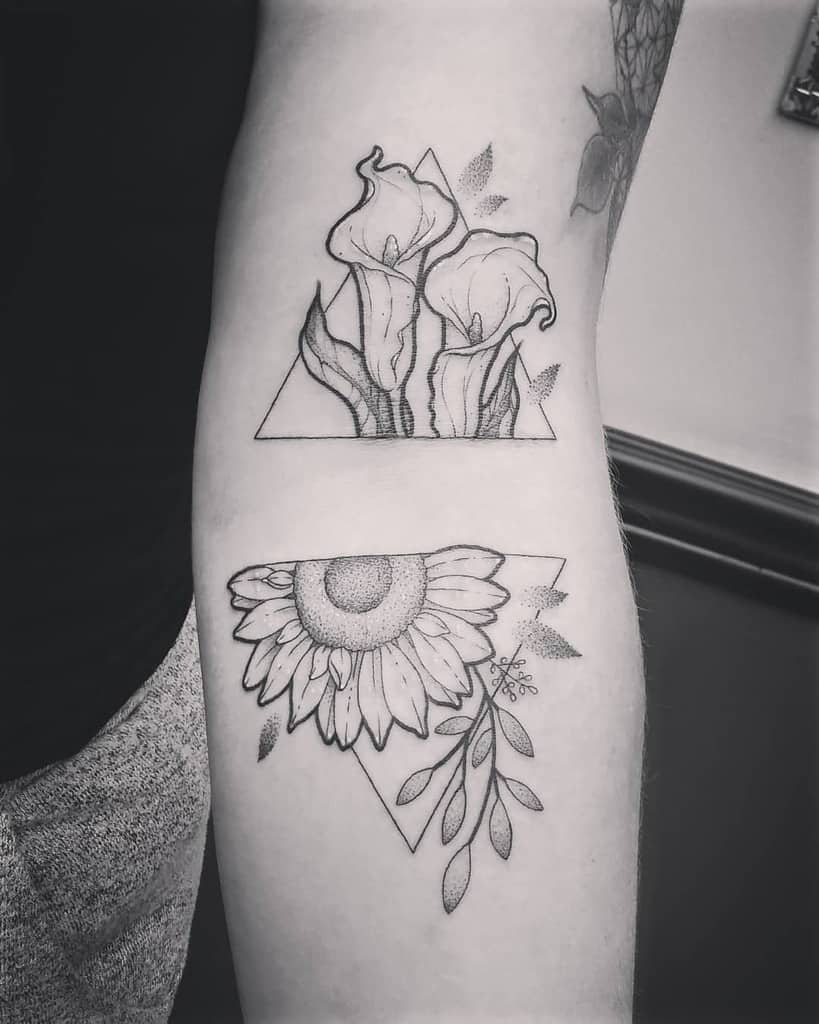 Black and grey arm tattoos featuring a geometric calla lily design on top and a sunflower with leaves below, both with fine line details.