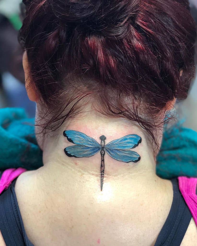 Vibrant blue dragonfly tattoo on the upper neck, featuring detailed wings and fine shading for a realistic effect.