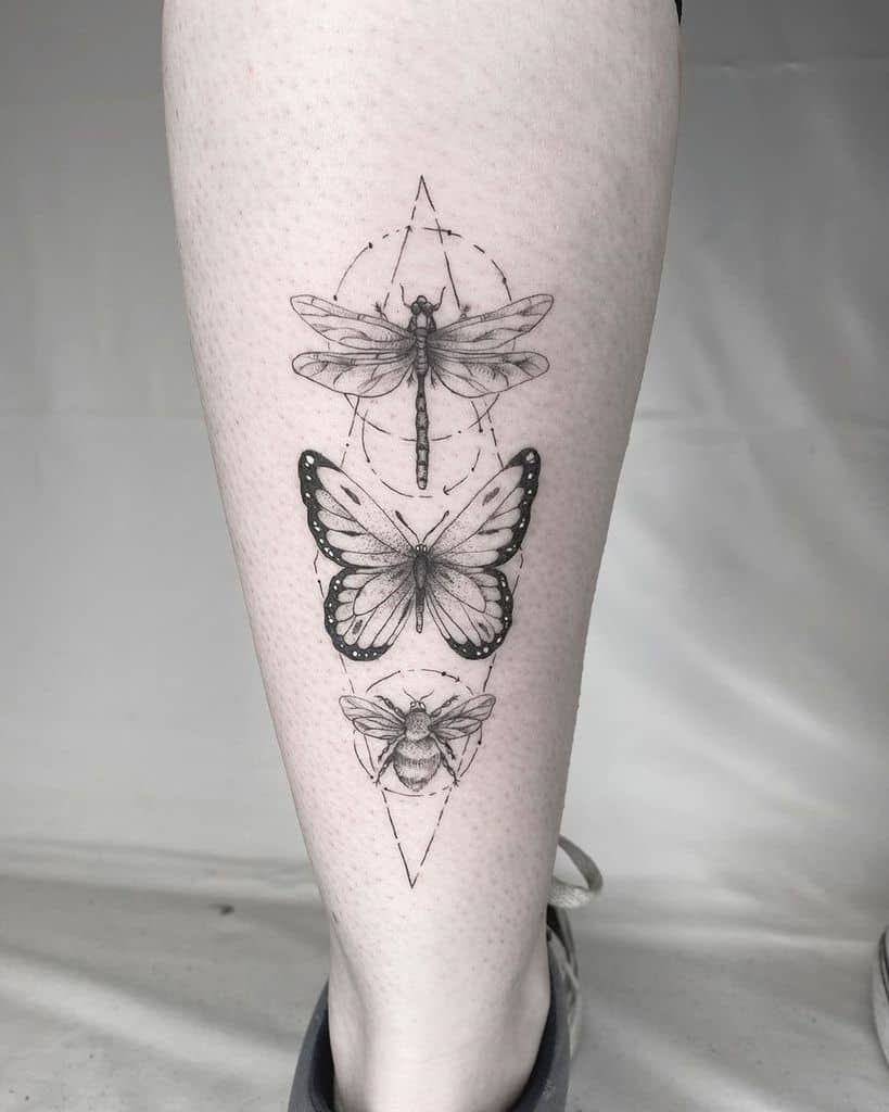 Fine-line nature-inspired tattoo on the calf, featuring a dragonfly, butterfly, and bee in a symmetrical geometric design.