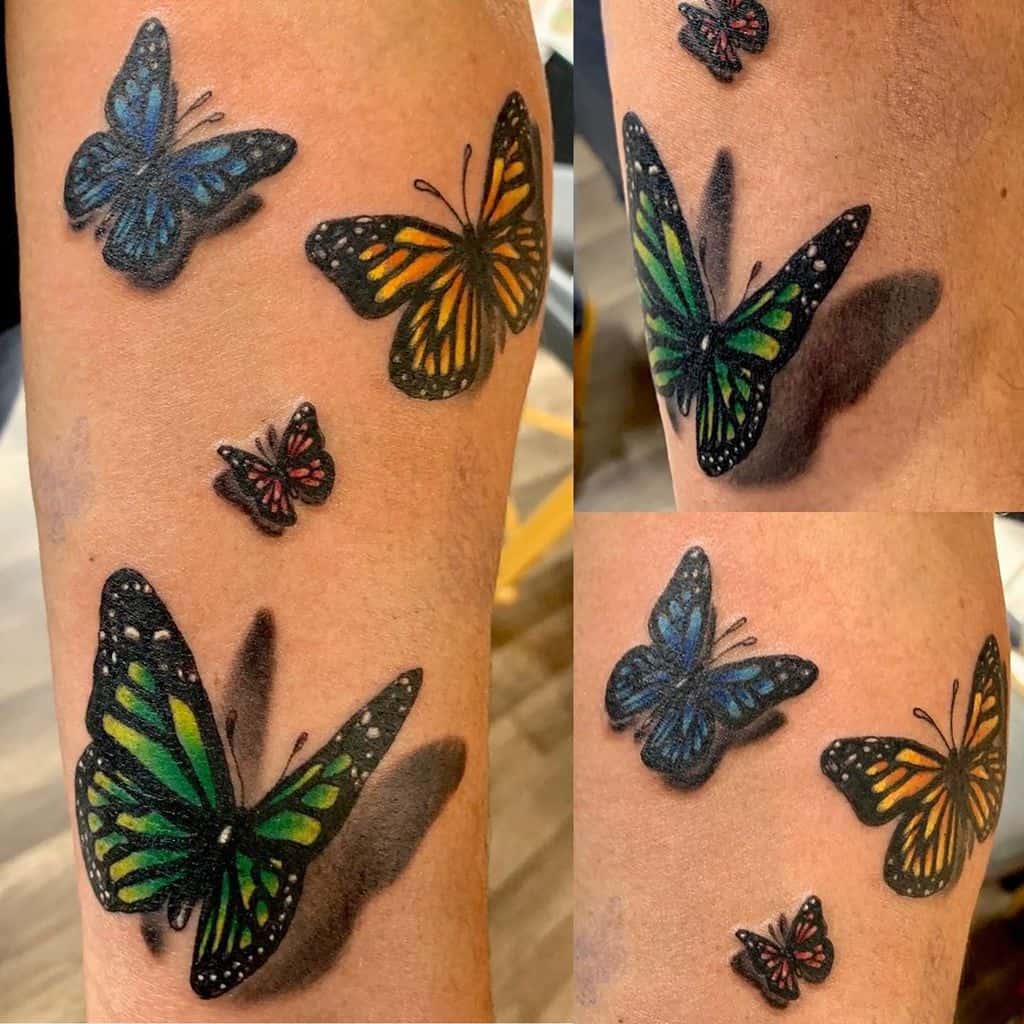 Vibrant multi-colored butterfly tattoo with a stunning 3D shadow effect, creating a lifelike and dynamic appearance on the skin.