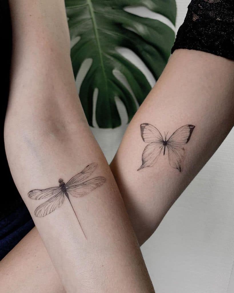 Matching fine-line tattoos of a dragonfly and butterfly on forearms, featuring delicate shading for an elegant and minimalistic look.