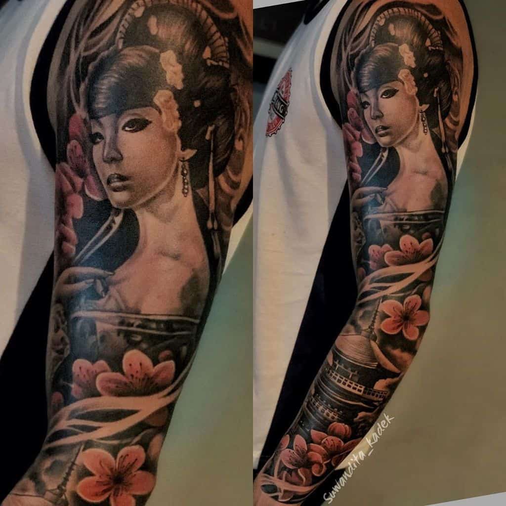 Realistic full-sleeve tattoo of a Geisha with intricate shading, cherry blossoms, and a traditional Japanese pagoda in a detailed black and gray style.