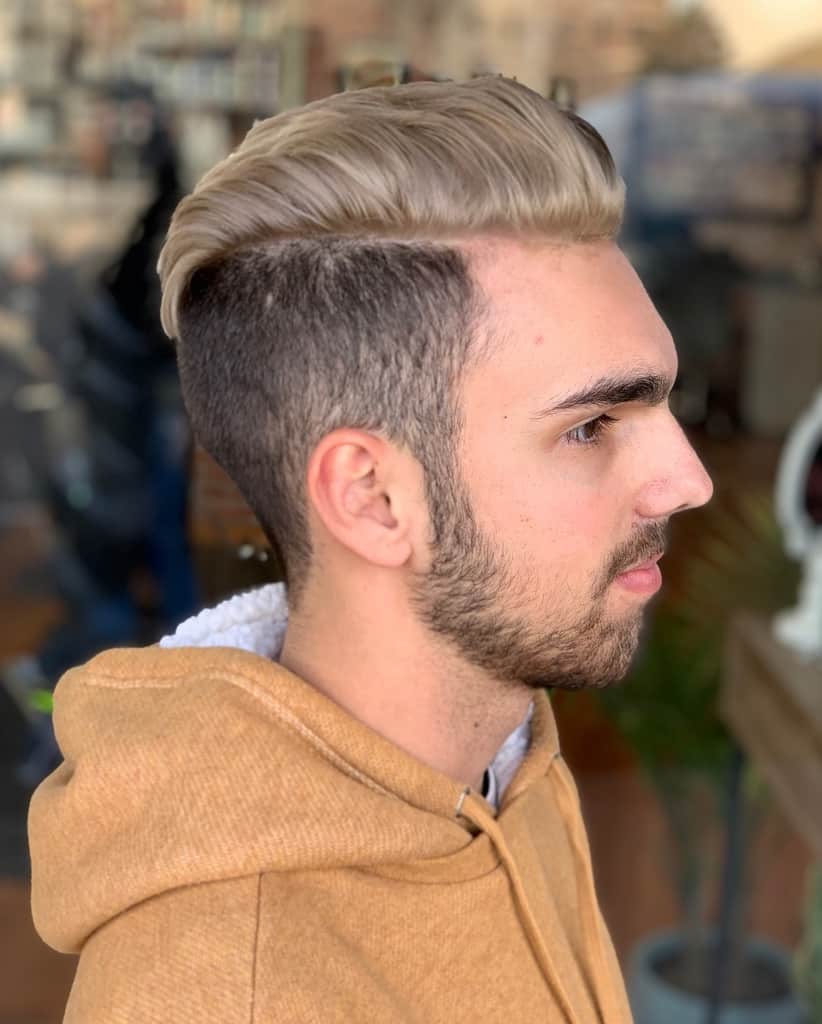 A Blond Haircut For Men With Brushed Back Long Hair On Top And Short Sides