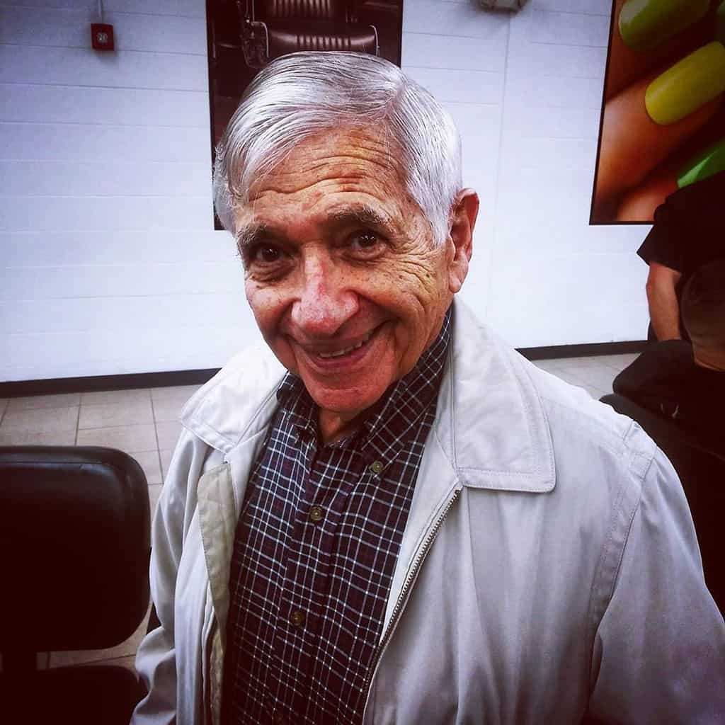 A Comb Over Haircut For Gray Hair Paired With Small Pomp