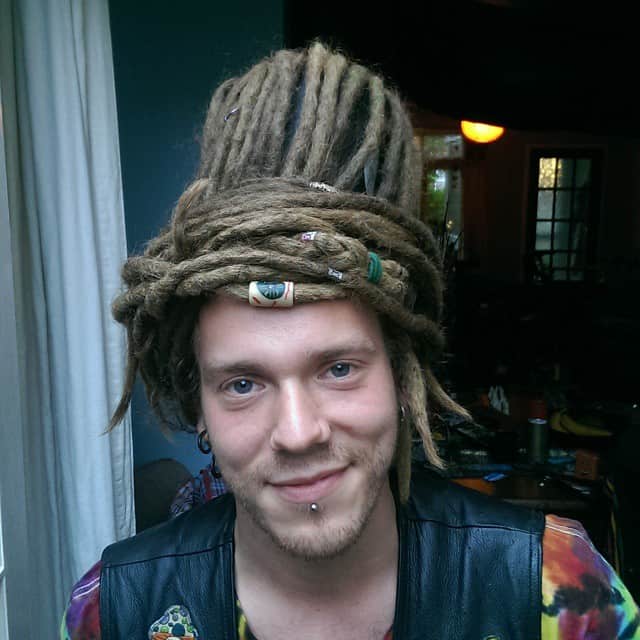 A Dreadlock Style With Heavy Dreads On Top Forming A Bun