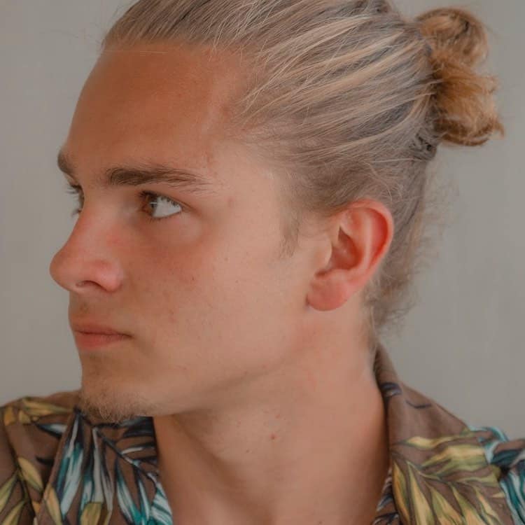 A Hairstyle For Blond Men Featuring Long Hair Styled Into A Man Bun At The Back