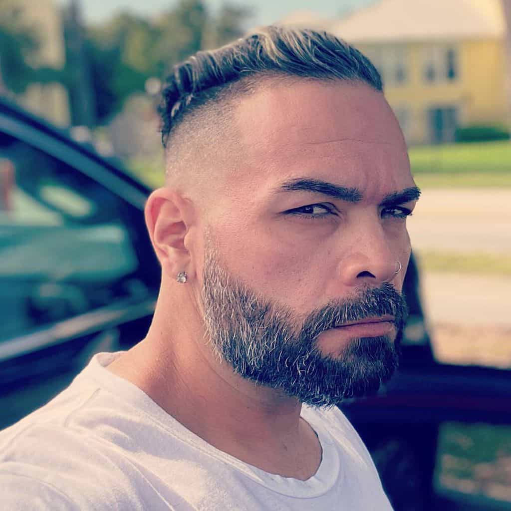 A High Fade Cut With An Undercut And Extended Sideburns