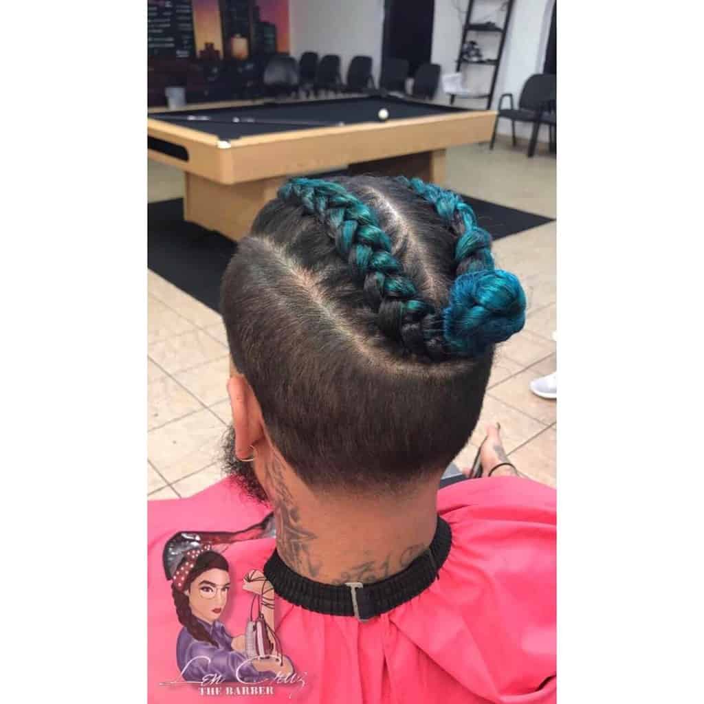 A Man Bun Undercut Style Featuring Long Dyed Hair On Top And Undercut With Natural Shade