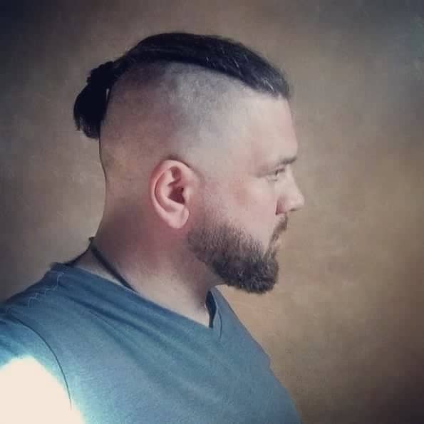 A Man Bun Undercut Style Paired With Clean Shaved Part
