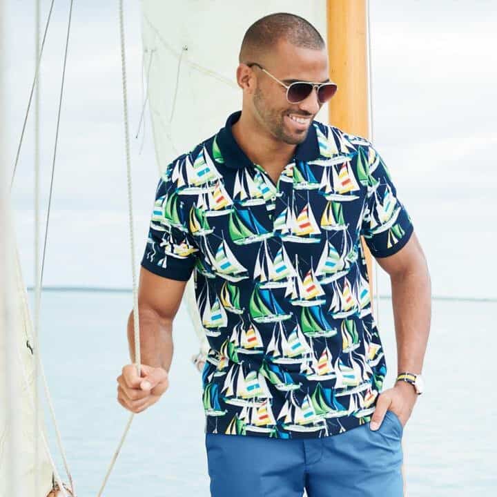 A Man Wearing Aviator Style Sunglasses Smiling On A Boat