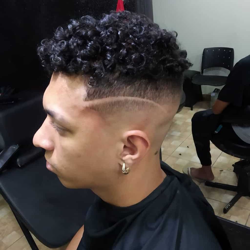 A Man Wearing High Top Skin Fade Where The Hair On The Sides And Back Fades Into The Skin