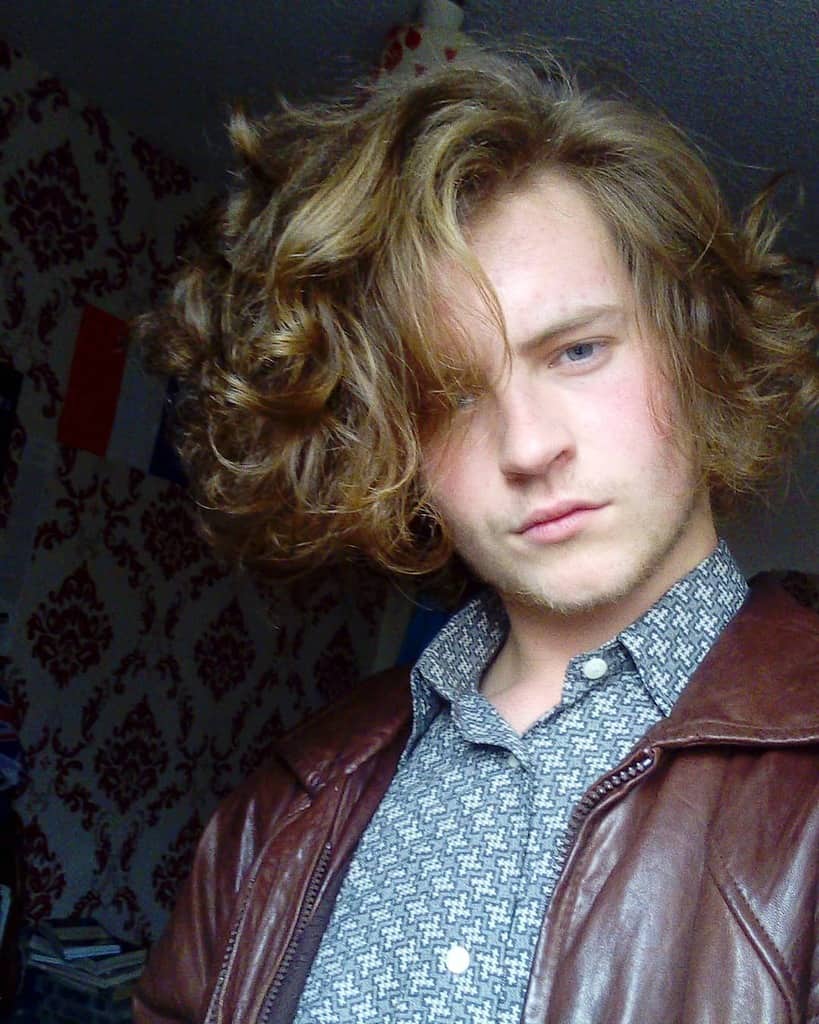 A Modern Jewfro Hairstyle With A Side Part In The Front