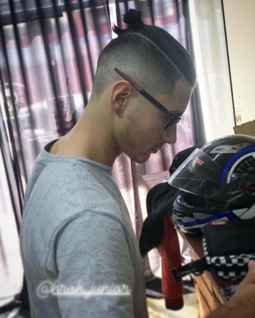 A Typical Man Bun Hairstyle Paired With Short Hair Undercut