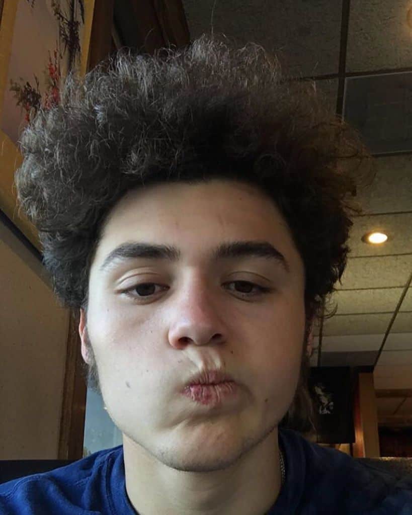 A ‘fro Hairstyle With Teased Hair To Enhance Volume