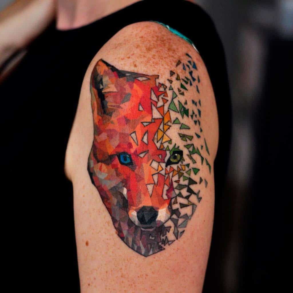 Geometric tattoo of a fox on someone's upper arm with vibrant colors and a fragmented geometric fox design