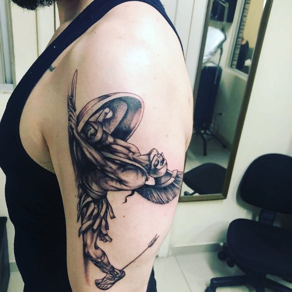 Arm tattoo of Achilles on the left upper arm